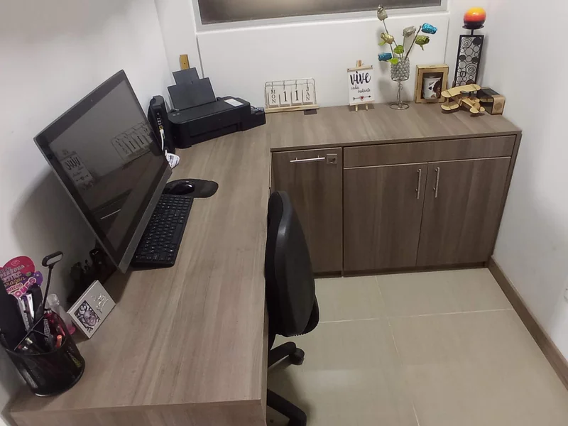 Oficina en L con gabinete bajo y escritorio ergonómico